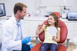 Young patient with dentist in dental clinic